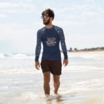 Make a Splash in Style: Vibrant Prints & UPF 50+ in this Men's Rash Guard (Image of a man swimming in the rash guard with colorful fish)