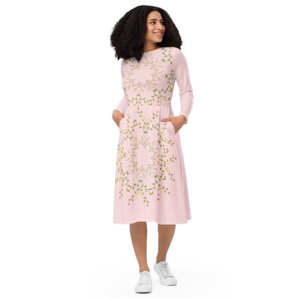 A model confidently twirling in a beautiful Teeslo midi dress.