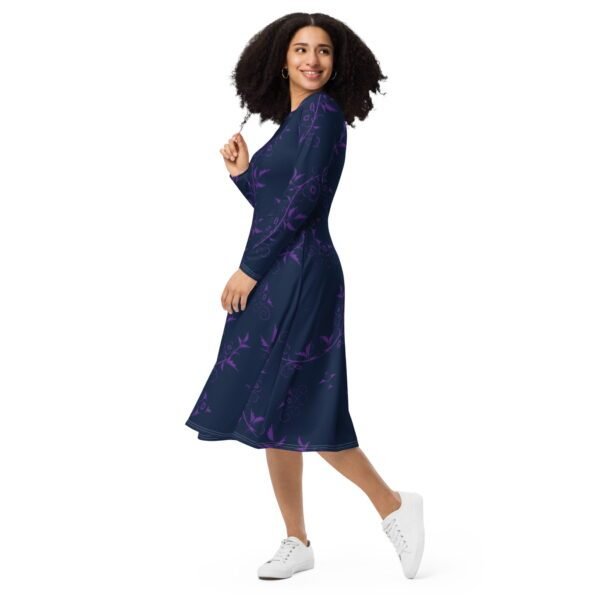 A person wearing a colorful all-over print midi dress with long sleeves and pockets. front side