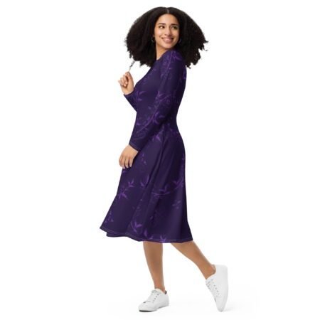 A person wearing a colorful all-over print midi dress with long sleeves and pockets. front side